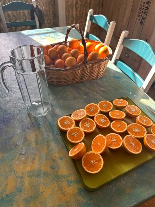 Fresh sliced oranges and whole fruits in basket at Pink-Shell B&B breakfast table in Santiago de Riba-UI, Portugal