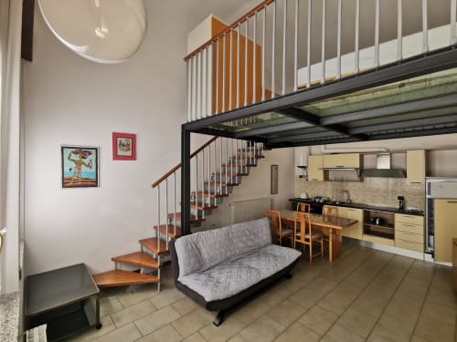 Modern loft apartment at The Kraken Inn in Bergamo with mezzanine bedroom, kitchen, and contemporary living space