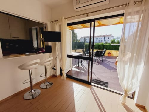 Apartamento moderno com acesso à varanda em Algarve Beach Holidays, apresentando sala de estar e varanda com vista para o oceano.