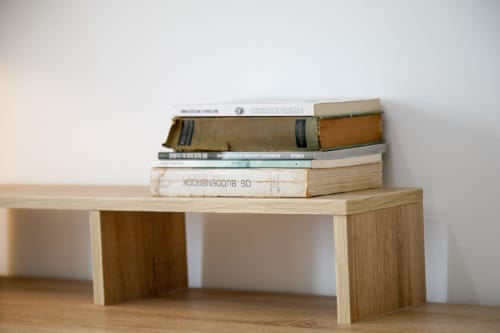 Stack of books on wooden desk at Lisbon Poets Inn hostel in Lisboa
