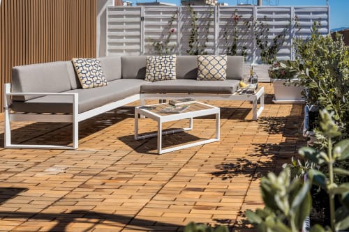 Terrazza panoramica Bluemoon Sardegna a Cagliari con sedute a L moderne, plancia in legno e viste sulla città