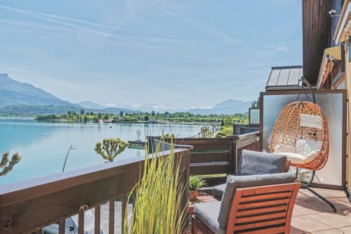 Emmlea apartment balcony overlooking Lake Annecy with hanging chair and mountain views, Tresserve