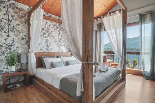Luxurious canopy bed in Le Lac Suspendu suite at Emmlea, Tresserve, with lake views and balcony