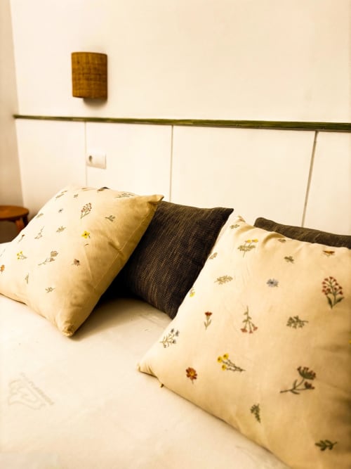Bed pillows with floral pattern at Mas Ribas Hotel in Palamós, Spain