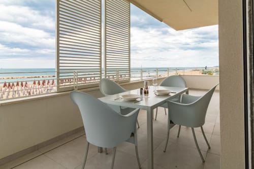 Sea view balcony at Pescara INN with dining table and chairs overlooking Adriatic coast