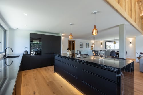 Modern luxury kitchen with black cabinetry and island in Chalet Magy 3, Les Gets