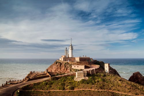 Lighthouse on rocky coastal peninsula at Cabo de Gata Almería near Hostal Las Dunas
