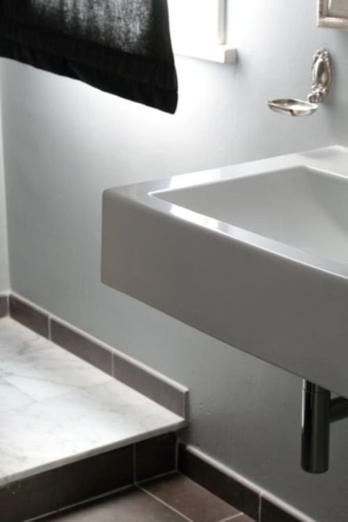 Lavabo moderno bianco con rubinetto cromato presso il B&B Le Biciclette a San Vito Lo Capo