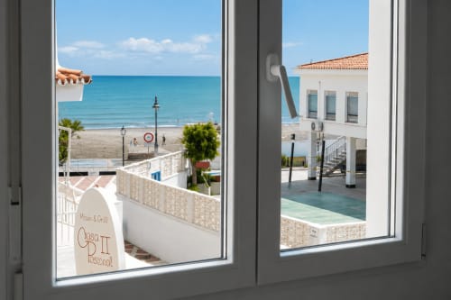 Widok na morze z okna apartamentu w Torremolinos z widokiem na plażę, brzeg Morza Śródziemnego i przomenadę nadmorską