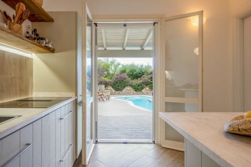 Modern kitchen with pool view at Top Villas Sardinia, Quartu Sant'Elena