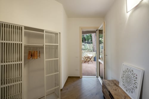 Modern hallway at Top Villas Sardinia with sliding doors, wooden flooring, and terrace access in Quartu Sant'Elena