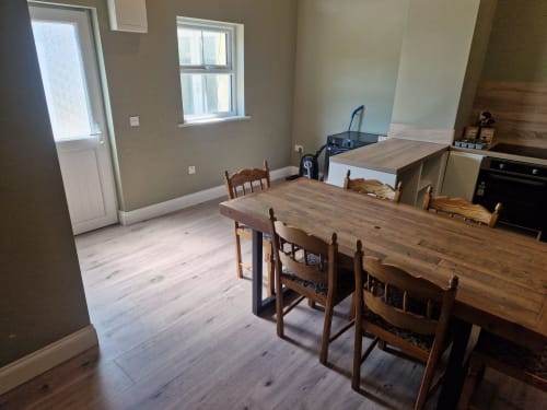 Spacious kitchen-dining area at Boswell Equestrian Centre apartment with wooden tables, chairs, and modern appliances in