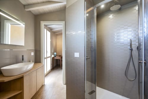 Modern bathroom at Top Villas Sardinia with walk-in shower, vessel sink, and contemporary fixtures