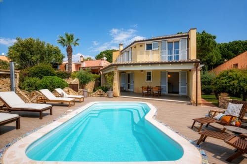 Villa Tigli pool area in Quartu Sant'Elena with turquoise swimming pool, lounge chairs, and modern house