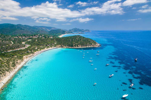 Turquoise Mediterranean cove with boats near Top Villas Sardinia, Quartu Sant'Elena