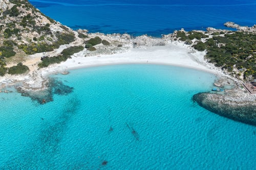 Turquoise waters and white sand beach cove at Top Villas Sardinia, Quartu Sant'Elena