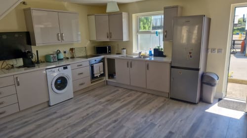 Modern kitchen in The Studio apartment at Boswell Equestrian Centre, Ashford, with stainless steel appliances and wooden