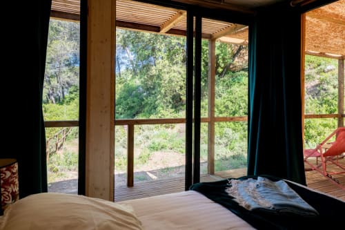 Bedroom with forest views at Le chant des pins Lodges, Saint-Marc-Jaumegarde. Large windows open to pine trees and wooden