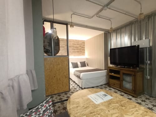Moderno apartamento estudio en Sevilla con cama, TV, cocina americana y sofá en diseño abierto