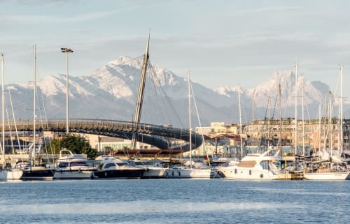 Marina in Pescara with sailboats, snow-capped mountains in background