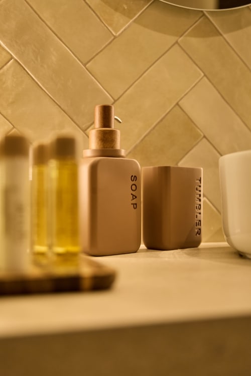 Luxury bathroom amenities including soap and toiletries displayed on a tiled counter at Arrels Mercat hotel in Valencia