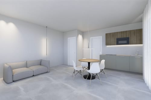 Suite Junior Balcone moderna presso Holiday Suites con divano grigio, tavolo rotondo, angolo cottura e design minimalista contemporaneo