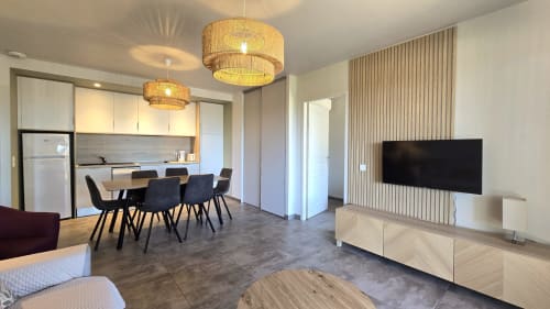 Modern 2-bedroom villa interior at Villas Lantana, Lecci with open-plan living, dining, kitchen and flat-screen TV