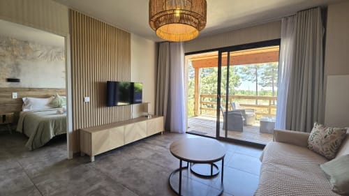 Spacious villa suite at Villas Lantana in Lecci with open-plan living, bedroom, flat-screen TV, and terrace access