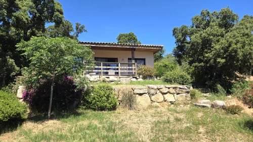 Villas Lantana villa in Lecci with stone terrace, blue railings, surrounded by green trees and flowering plants