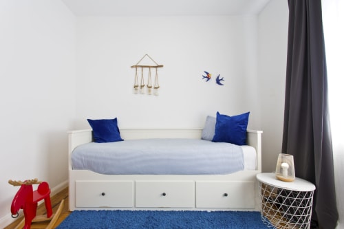 Modern family bedroom at 100 Contos Porto B&B with white bed, blue accents, wooden floor, and city view
