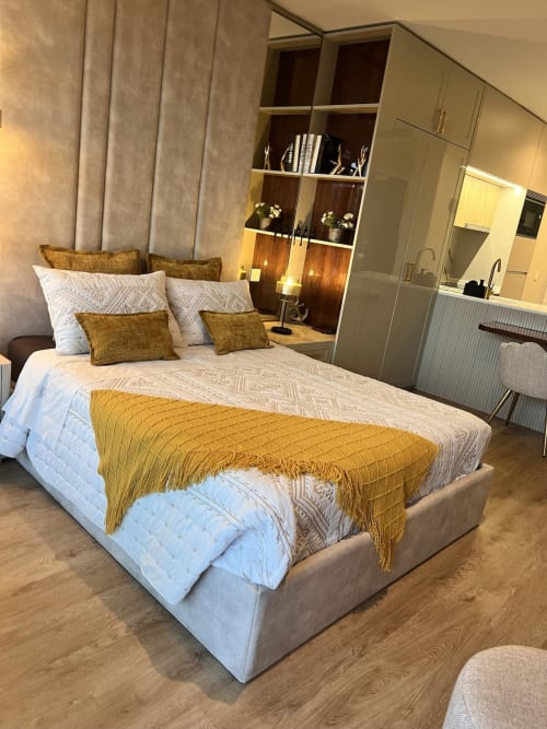 Studio de luxo em Timeless Vacations Arcozelo com detalhes em ouro, roupa de cama branca e prateleiras com vista para o rio.