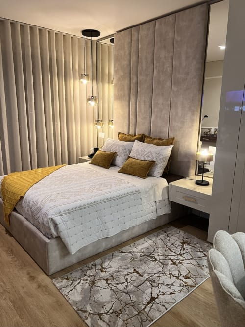 Quarto moderno na Timeless Vacations Arcozelo com cama, detalhes dourados, luminárias pendentes, cortinas e vista para o rio.