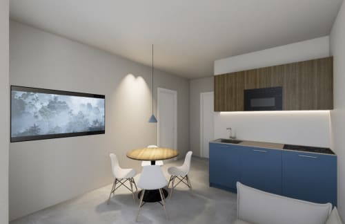 Camera d'hotel Modern Holiday Suites con cucina blu, tavolo da pranzo rotondo, TV a parete e illuminazione a sospensione