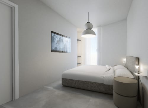 Camera moderna delle Holiday Suites con letto imbottito grigio, illuminazione a sospensione e arredamento minimalista