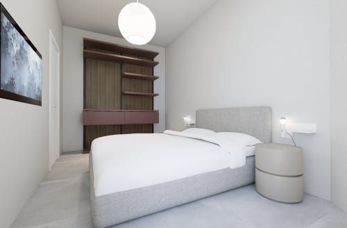 Camera moderna alle Holiday Suites con letto imbottito grigio, biancheria bianca, comodini cilindrici e armadio in legno scuro