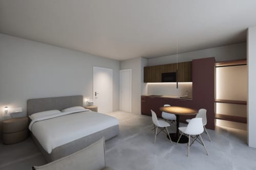 Junior Suite moderna di Holiday Suites con letto queen, angolo cottura, tavolo da pranzo e arredi contemporanei