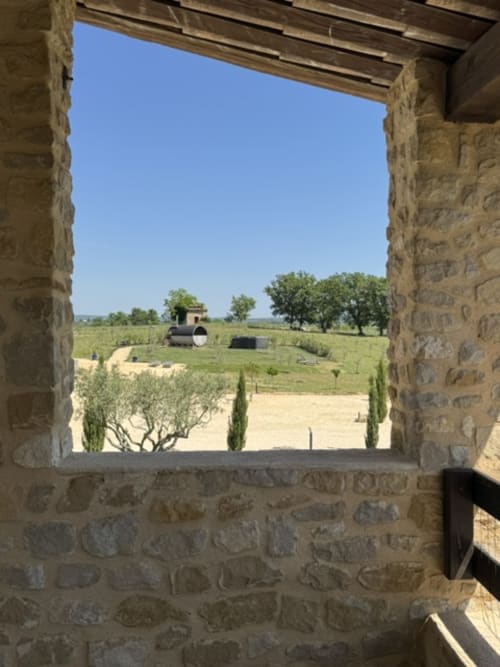 Stenen raamzicht op het platteland van L'arbre Qui Chante B&B in Saint Sauveur de Cruzières met olijfbomen en landelijk landschap