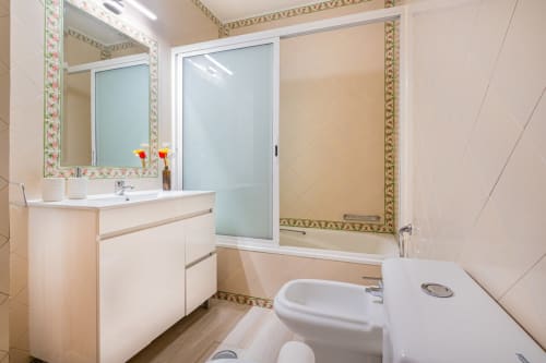 Banheiro moderno no Heart of Oura by SignatureStays em Albufeira com pia branca, espelho, bidê e box de chuveiro