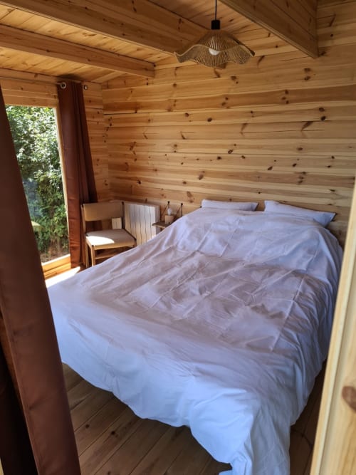 Cozy wooden bedroom with white bedding at La Maison de Dun B&B, Cèdre Bleu room, Saint Racho