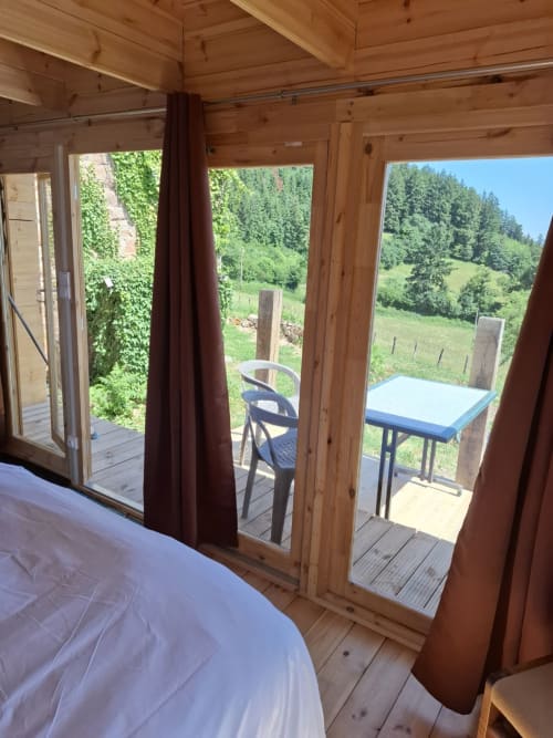Cèdre Bleu bedroom at La Maison de Dun B&B with glass doors opening to mountain views in Saint Racho, France