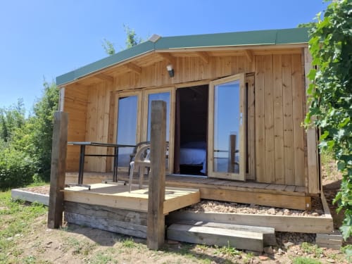 Cèdre Bleu room at La Maison de Dun B&B in Saint Racho with wooden cabin, patio, and mountain views