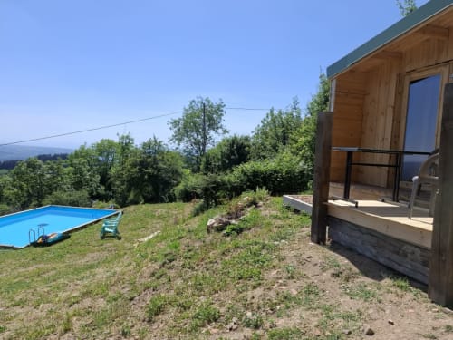 Cèdre Bleu room at La Maison de Dun with mountain views, pool, and wooden cabin patio, Saint Racho