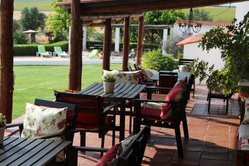 Terrace seating area at Monte da Morena with black furniture, red cushions, and views of the grounds in Serpa, Portugal