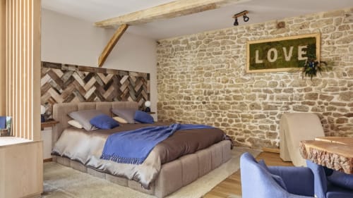 Luxury bedroom in La suite de l'Etoile cottage at L'etoile De Forges, Longmesnil, with stone walls and wooden beams