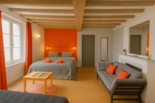 Studio charmant à Maunoury Citybreak à Chartres avec mur d'accent orange, poutres en bois, lit, canapé et éléments en bois