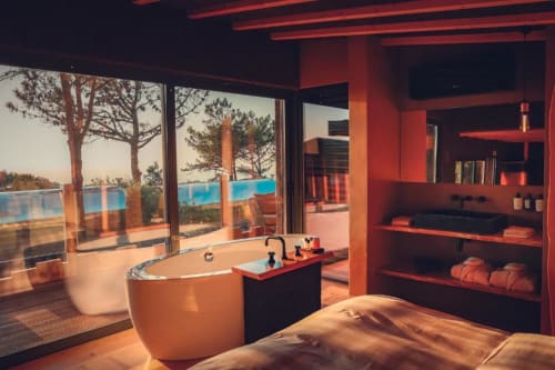 Luxury bathroom with freestanding tub, ocean view, red neon lighting at Charm Nature BnB, Azóia, Portugal