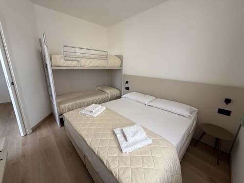 Bilocale Superior apartment at Residenza Sant'Antonio featuring bunk beds and double bed with white linens