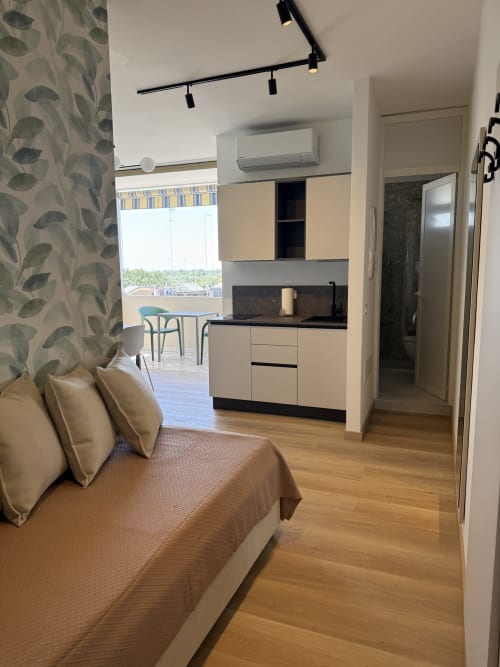 Bilocale Superior at Residenza Sant'Antonio, Sottomarina: modern studio apartment with bed, kitchenette, and balcony