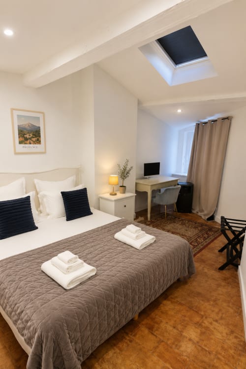 Suite Mirabeau at Les Suites de Montigny, Aix-en-Provence: modern bedroom with twin beds, work desk, skylight, and garden