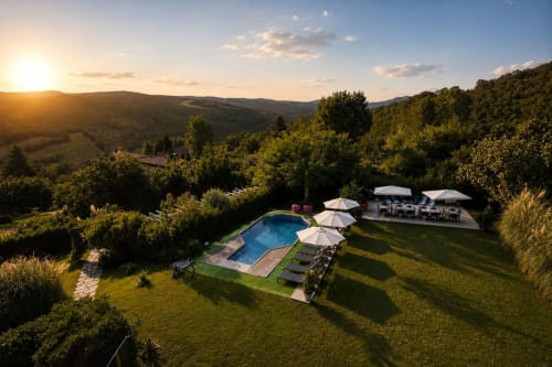 Piscina del Gan Eden B&B con ombrelloni con vista sulle colline della Toscana al tramonto a San Benedetto del Querceto